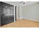 Bedroom featuring hardwood floors, a ceiling fan, and a spacious closet at 405 Amberjack Way, Summerville, SC 29485