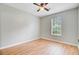 Empty bedroom with wood floors, fresh paint, a ceiling fan, and large window at 405 Amberjack Way, Summerville, SC 29485