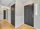 Hallway featuring modern paneling and light-colored wood flooring, showcasing elegant doors and a bright, airy feel at 405 Amberjack Way, Summerville, SC 29485