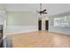 Expansive living room featuring light wood flooring, a fireplace, and neutral walls, creating a welcoming and versatile space at 405 Amberjack Way, Summerville, SC 29485