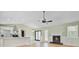 Open living space featuring a fireplace, a kitchen with a peninsula, and light-colored walls and flooring at 405 Amberjack Way, Summerville, SC 29485