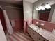 Pink tiled bathroom featuring a sink, vanity, and a shower with a curtain at 409 Azalea Dr, Walterboro, SC 29488