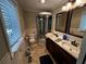 Well-lit bathroom featuring double sinks, tiled floors and a glass shower enclosure at 409 Azalea Dr, Walterboro, SC 29488