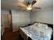 Bedroom features a comfortable bed, hardwood floors, a ceiling fan, natural light, and closet at 409 Azalea Dr, Walterboro, SC 29488