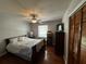 Bedroom features a comfortable bed, hardwood floors, a ceiling fan, natural light, and closet at 409 Azalea Dr, Walterboro, SC 29488