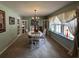 Light and airy dining room with large windows, chandelier, and charming built-in cabinets at 409 Azalea Dr, Walterboro, SC 29488