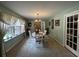 Dining room with large windows, chandelier, and charming built-in cabinets at 409 Azalea Dr, Walterboro, SC 29488