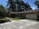 Charming brick home featuring an attached garage, green shutters, and concrete driveway at 409 Azalea Dr, Walterboro, SC 29488