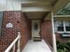 Charming brick home entrance with a beige front door and a cozy covered porch area at 409 Azalea Dr, Walterboro, SC 29488