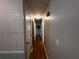 Hallway with hardwood floors, neutral walls and doors leading to bedrooms at 409 Azalea Dr, Walterboro, SC 29488