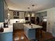Beautiful kitchen with stone countertops, stainless steel appliances, kitchen island and hardwood floors at 409 Azalea Dr, Walterboro, SC 29488