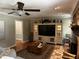 Cozy living room with hardwood floors, brick fireplace, built-in shelving, and neutral decor at 409 Azalea Dr, Walterboro, SC 29488