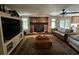 Open-concept living room with a brick fireplace, wooden floors, and a comfortable seating area at 409 Azalea Dr, Walterboro, SC 29488