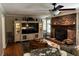 Inviting living room featuring a brick fireplace and a large entertainment center with display shelves at 409 Azalea Dr, Walterboro, SC 29488