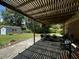 Shaded patio area with seating, adjacent to a shed and green lawn at 409 Azalea Dr, Walterboro, SC 29488