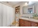 Bathroom features a vanity with granite counter, wood cabinets, toilet, and shower with a white curtain at 4636 Ashley View Ln, North Charleston, SC 29405