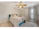 Bright bedroom features carpet, neutral walls, ceiling fan, window, and large bed with decorative pillows at 4636 Ashley View Ln, North Charleston, SC 29405