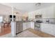 Open kitchen with stainless steel appliances, white cabinets, and breakfast bar overlooking the living area at 4636 Ashley View Ln, North Charleston, SC 29405