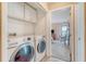 Laundry room with white appliances and built-in shelving at 4636 Ashley View Ln, North Charleston, SC 29405