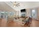 Bright living room featuring a fireplace, ceiling fan, hardwood floors, and large windows at 4636 Ashley View Ln, North Charleston, SC 29405