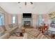 Cozy living room with a fireplace, hardwood floors, neutral colors, and comfortable seating at 4636 Ashley View Ln, North Charleston, SC 29405