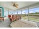 Spacious screened porch with wicker furniture, ceiling fan, and hot tub overlooking the marsh at 4636 Ashley View Ln, North Charleston, SC 29405