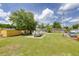 Large backyard featuring lush green grass and ample space with a boat and storage sheds at 5904 Oak Street, Hanahan, SC 29410