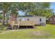 Backyard featuring a cozy wooden deck with stairs, perfect for relaxation and outdoor entertaining at 5904 Oak Street, Hanahan, SC 29410