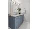 Stylish bathroom with blue vanity, granite countertop, and decorative mirror at 5904 Oak Street, Hanahan, SC 29410