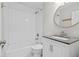 Clean, updated bathroom with white subway tile, modern vanity, and a stylish round mirror at 5904 Oak Street, Hanahan, SC 29410