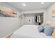 Well-lit bedroom featuring a comfy bed, open closet, hardwood floors, and beach themed decor at 5904 Oak Street, Hanahan, SC 29410