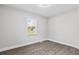 Well-lit bedroom featuring wood floors, a window, and neutral walls at 5904 Oak Street, Hanahan, SC 29410