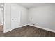 A well lit empty room featuring wood flooring, a door to the hall, and a water hookup at 5904 Oak Street, Hanahan, SC 29410