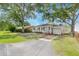 Charming home with a well-maintained front yard, featuring mature trees and a paved driveway at 5904 Oak Street, Hanahan, SC 29410