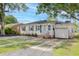 Inviting home with fresh landscaping, featuring a cozy front porch and a well-manicured lawn at 5904 Oak Street, Hanahan, SC 29410