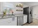 Bright kitchen featuring a stainless steel sink, updated appliances and open shelving at 5904 Oak Street, Hanahan, SC 29410