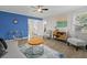 Contemporary living room with vibrant blue accent wall, modern furnishings, and an open floor plan at 5904 Oak Street, Hanahan, SC 29410