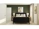 Stylish bedroom with a black rattan bed frame, neutral rug, and olive green accent wall at 620 Culpepper St, Summerville, SC 29486