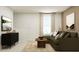 Comfortable living room with an olive sectional, media cabinet, and neutral-toned decor at 620 Culpepper St, Summerville, SC 29486