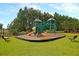 playground with colorful play structures and protective mulch under a lush green treescape at 620 Culpepper St, Summerville, SC 29486