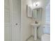 Bathroom featuring pedestal sink, white tiled floors, and large closet for storage at 6275 Rolling Fork Rd # 401, North Charleston, SC 29406