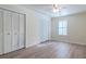 Neutral bedroom features modern ceiling fan, shuttered windows, and laminate flooring at 6275 Rolling Fork Rd # 401, North Charleston, SC 29406