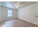 Neutral bedroom with light colored flooring, ceiling fan, and large shuttered window at 6275 Rolling Fork Rd # 401, North Charleston, SC 29406