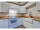 Charming kitchen features white cabinets, butcher block counters, and updated appliances at 6275 Rolling Fork Rd # 401, North Charleston, SC 29406