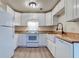Well-equipped kitchen boasts white cabinets, butcher block counters, and stainless steel appliances at 6275 Rolling Fork Rd # 401, North Charleston, SC 29406