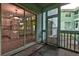 View from the screened-in porch showing the interior kitchen and outdoor green space at 6275 Rolling Fork Rd # 401, North Charleston, SC 29406