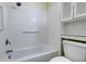Bathroom featuring a bathtub with shower, toilet, grab bars and a built in cabinet at 6280 Rolling Fork Rd # 302, North Charleston, SC 29406