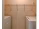 Functional laundry room area with washer, dryer, and shelving for organization at 6280 Rolling Fork Rd # 302, North Charleston, SC 29406