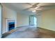Cozy living room features a fireplace and ample natural light with a ceiling fan at 6280 Rolling Fork Rd # 302, North Charleston, SC 29406