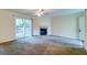 Open concept living room with fireplace, sliding glass door, and view of the entryway at 6280 Rolling Fork Rd # 302, North Charleston, SC 29406